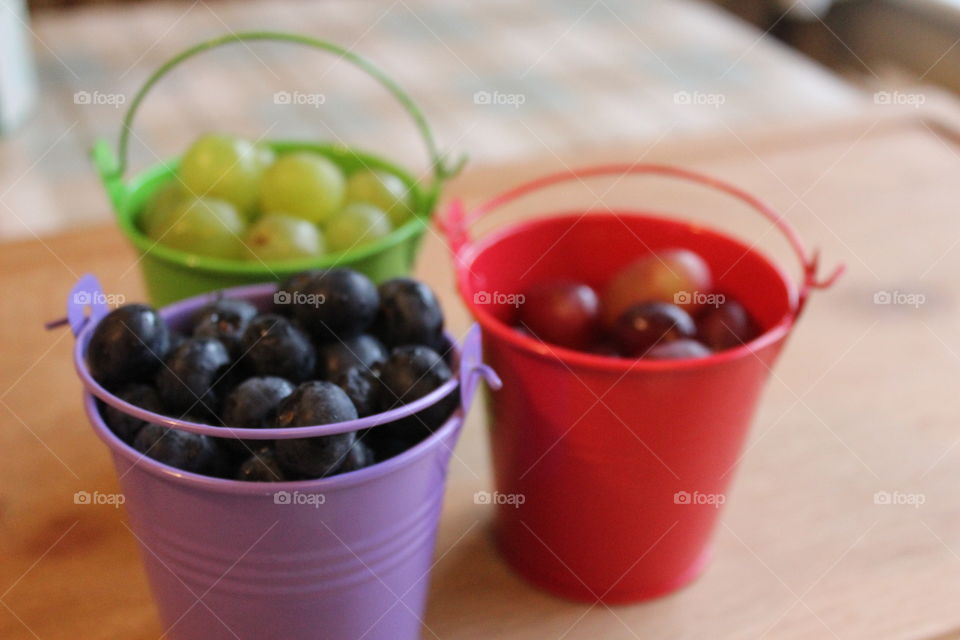 Blueberries and grapes in buckets