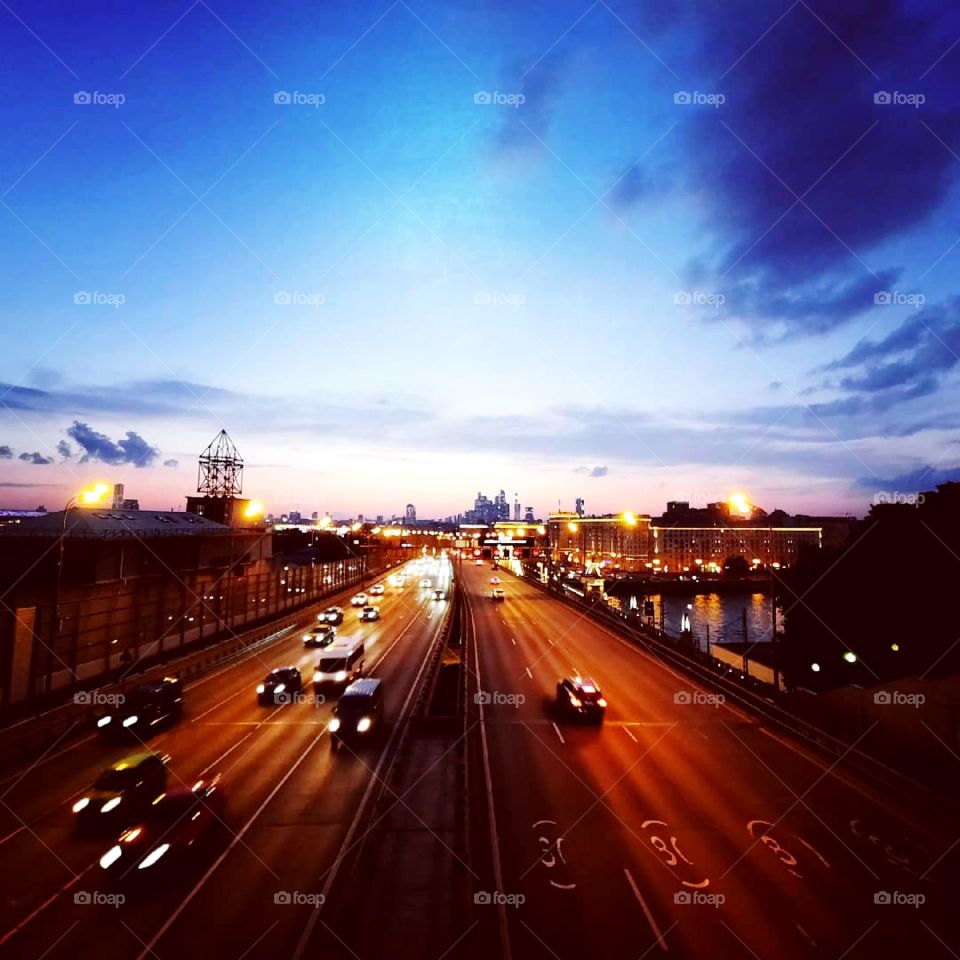 Busy road on the bridge over the river at disk