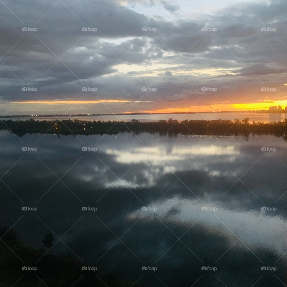 Mirror effect with a sunset and clouds on the St.Lawrence river, Quebec, Canada 🍁