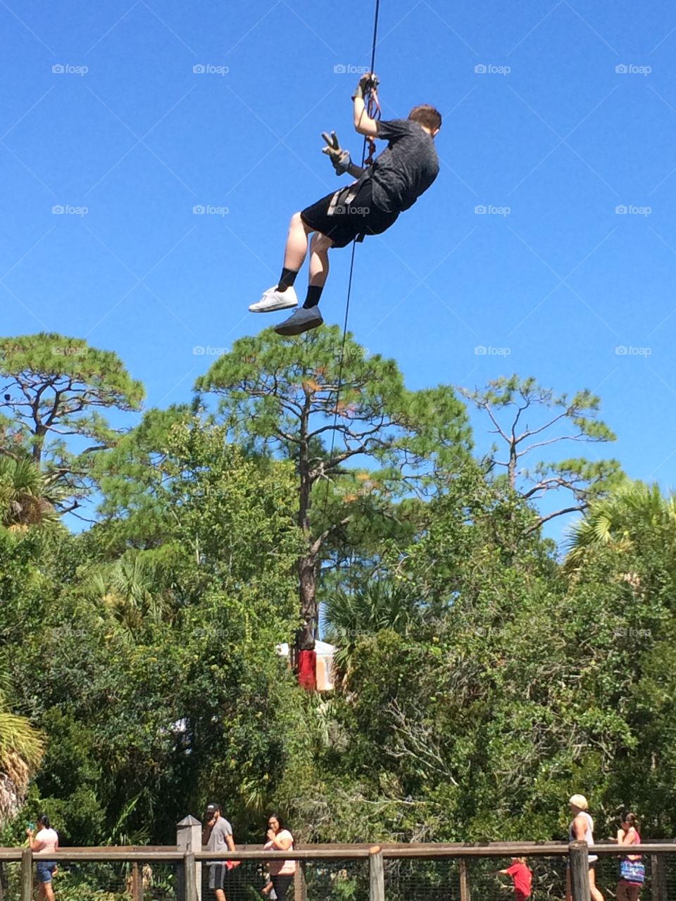 Zip lining across the river 
