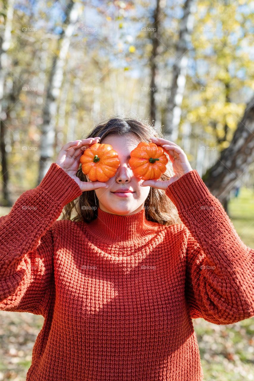 woman holding pumpkin