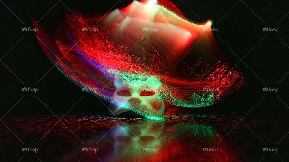 Cat mask with light trail on black background