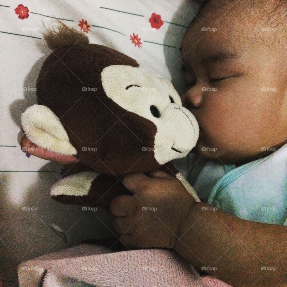 I love you. Love can be so universal, three months old baby sleeping peacefully with his beloved doll