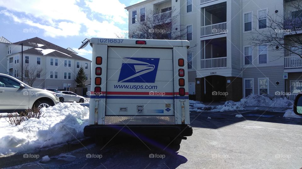 Buildings, apartments, mail truck