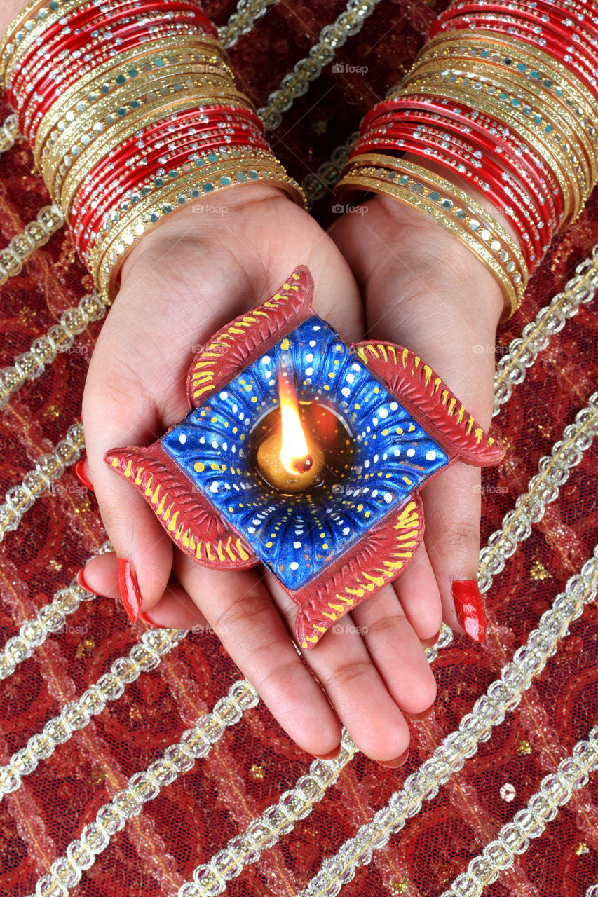 Indian festival Diwali diya in female hands