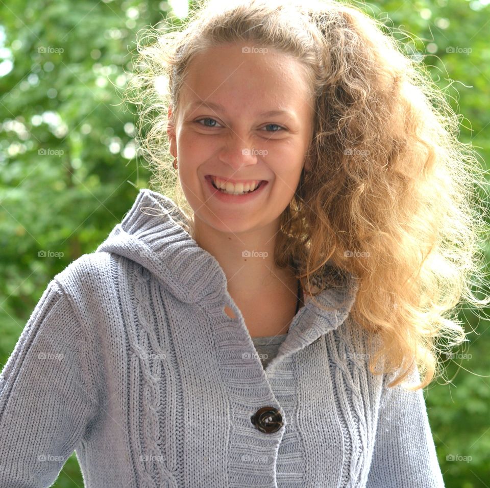 smiling teenage girl beautiful portrait green background