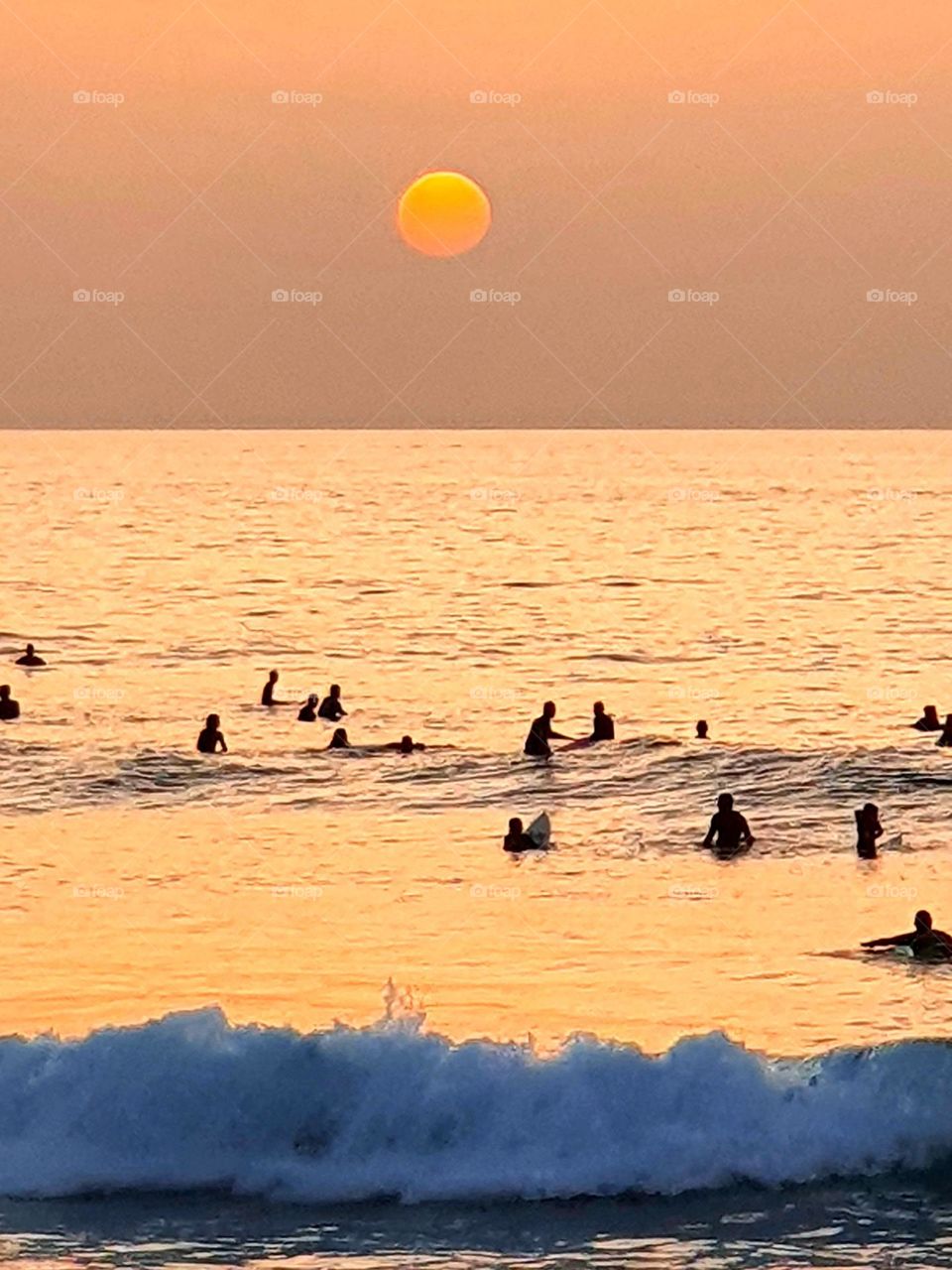 sunset at the ocean- Surfer are waiting for a wave-