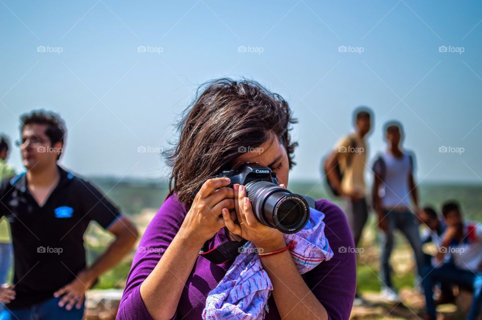 Girl Photographer. A girl using a Canon.