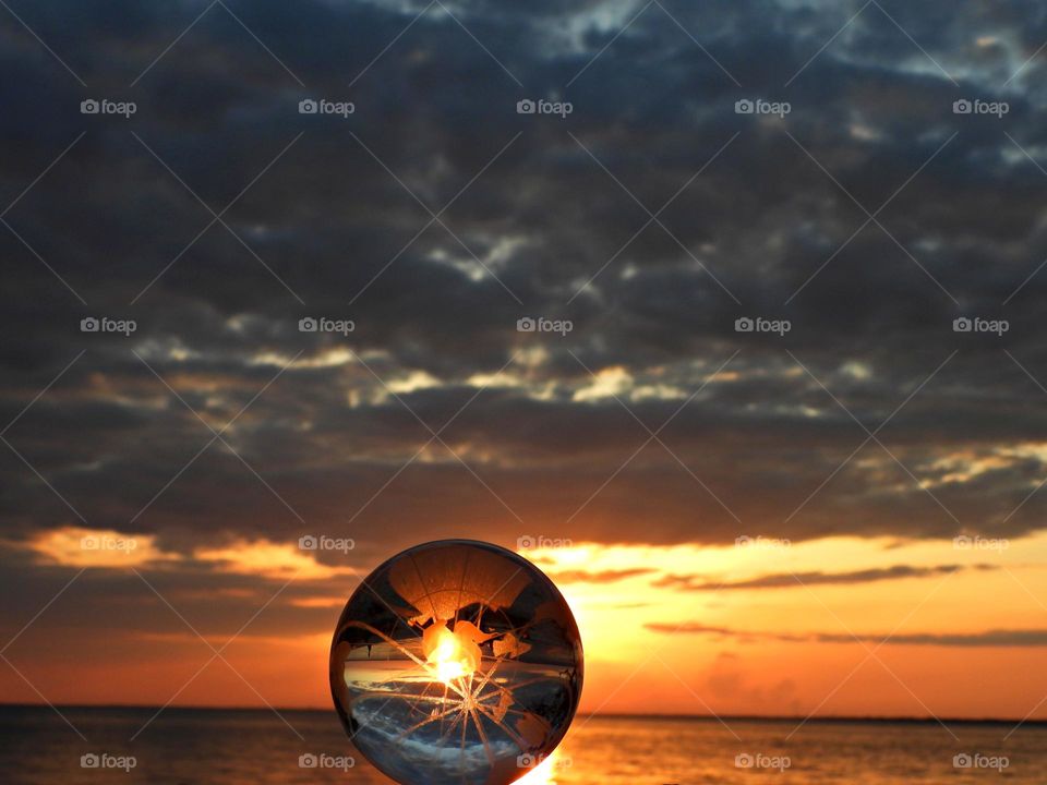 A spectacular sunset through a crystal ball. The sunset was a perfect conclusion of the day. It was a silky, and smooth collusion of sky burst of yellows, various hues, orange, tangerine and metallic gold