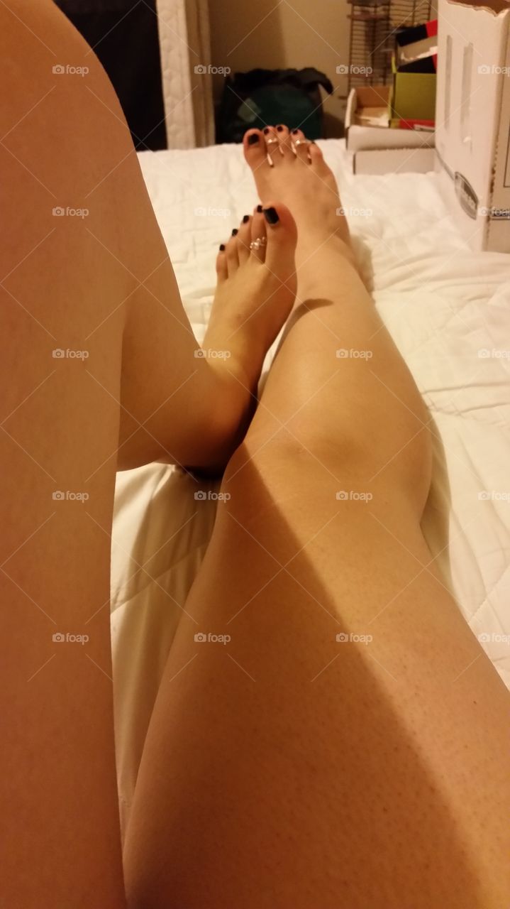 My pretty feet and legs while resting on my bed after a hard day at work.