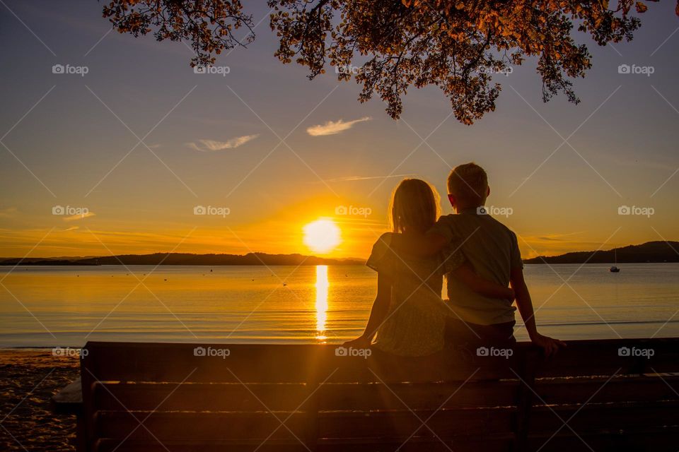 Brother and sister watching the sunset together . brotherhood and susterhood . ❤️🧡💛💚💙