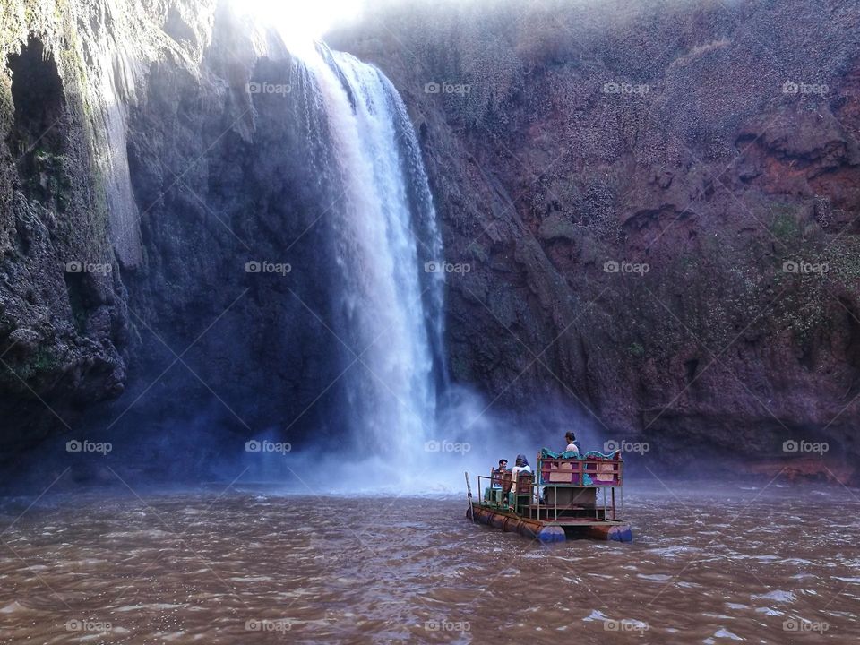typical Moroccan boat under the Ozoud waterfall in Morocco
