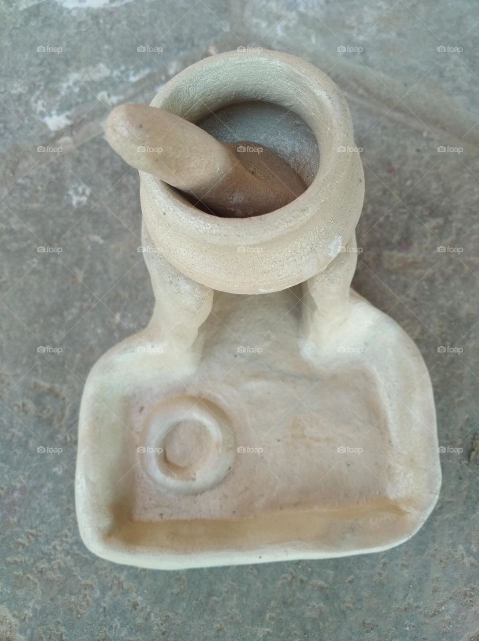 a handicraft items,desi chulha with a cooking pot made by soil desi stove