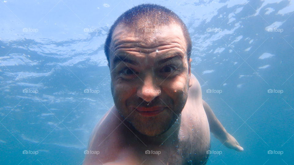 Man swimming underwater in sea