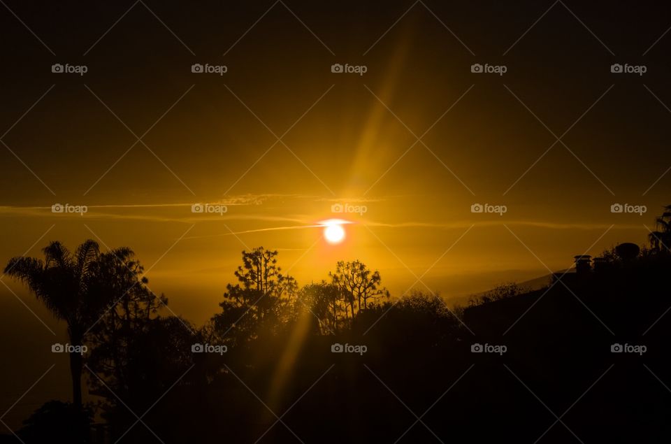 Sun setting under clouds