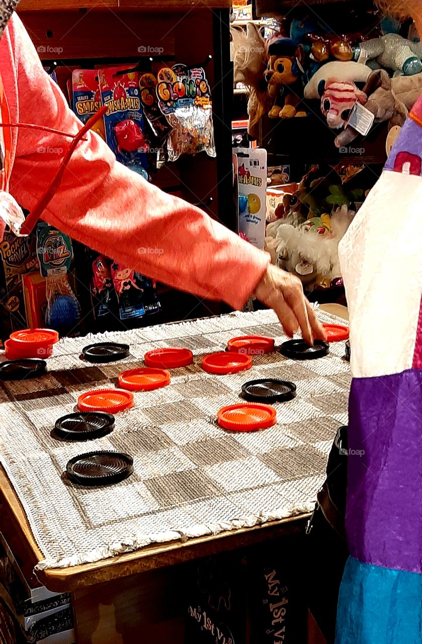 2 women playing a game of Checkers in the gift shop after dinner at the Cracker Barrel Old Country Store
