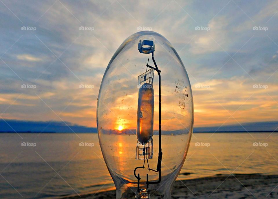 Sunset through a light bulb - Taking a descending sunset through an oval shaped lightbulb