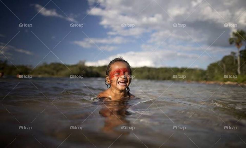 Small Indian boy of the caiapós tribe, taking his bath in the river. Brazil