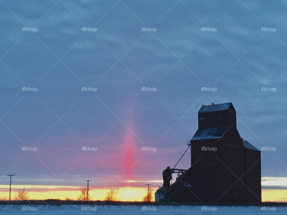 Old grain elevator at sunset 