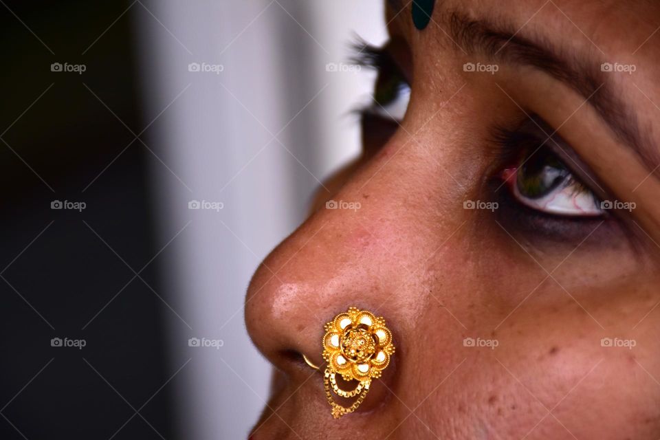 Indian woman wearing gold nose pin