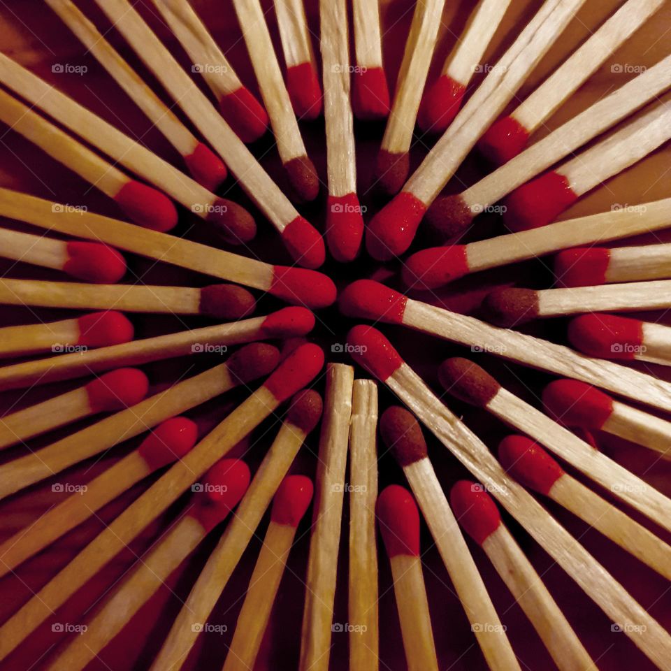 This picture is an artistic dandelion made of two-color matches. A circle can also be observed.