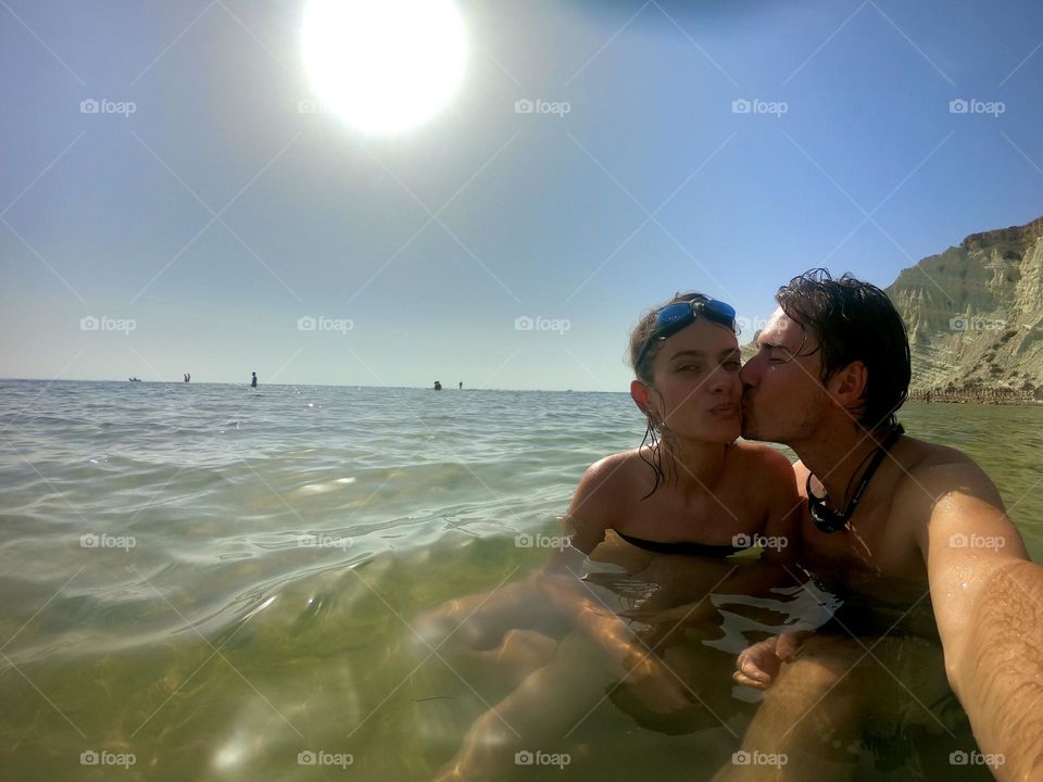 Couple taking a selfie in water