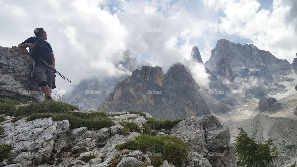 Hiker at high altitude viewing the high mountain peaks 