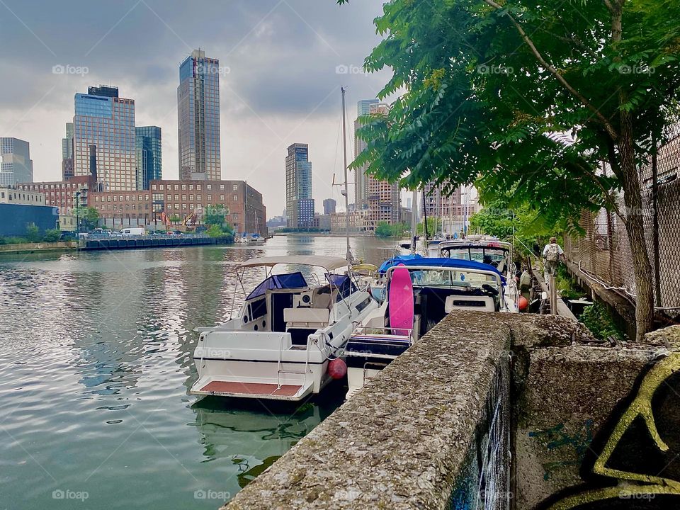“Newtown Creek” by the “Pulaski Bridge” in “Long Island City”, Queens is a central location in “New York City” that has what most other places don’t such as a variety of idyllic looking boats. 2023. Hypnotic Productions