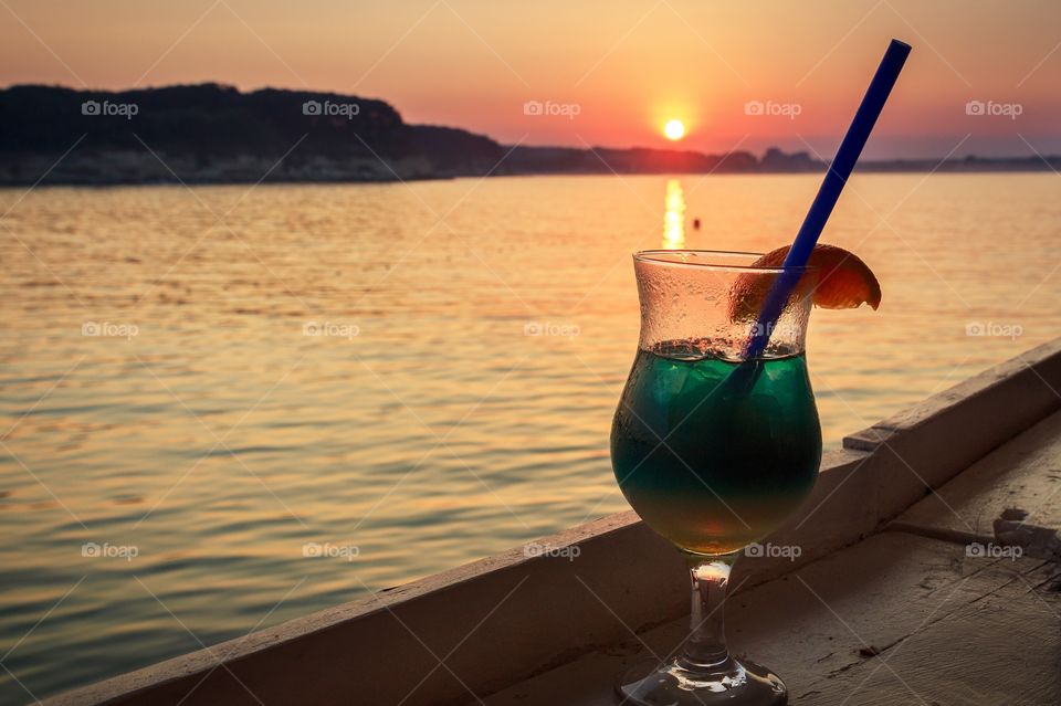 Beautiful sunset and cocktail on the beach