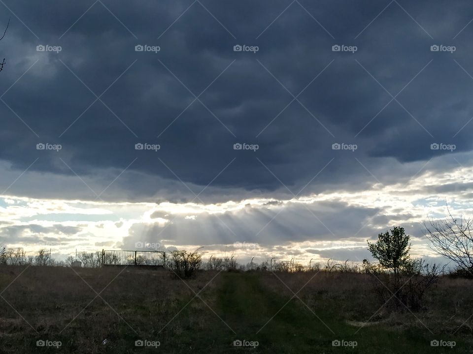 Sun rays and rainy clouds