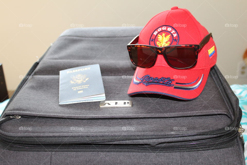 Packing my suitcase for summer vacation. Red Colombian cap, sunglasses and passport✈️