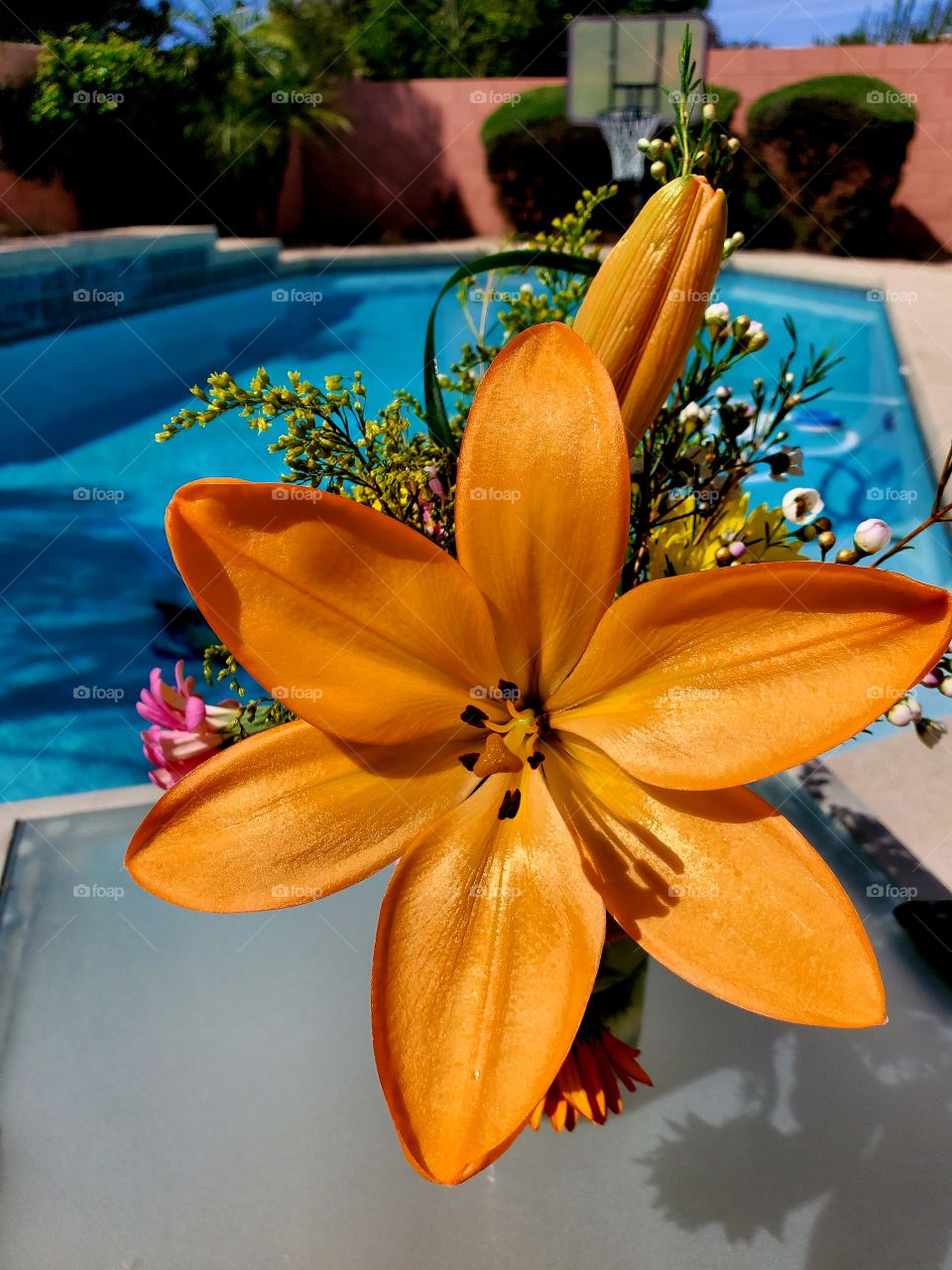 Floral bouquet sits poolside