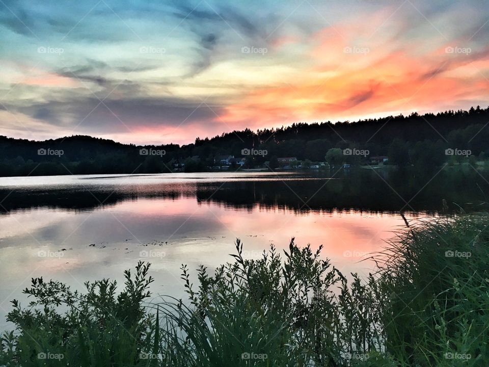 Colourful sunset reflected on the lake.