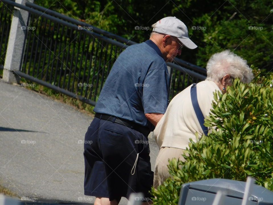 An elderly couple helping each other 