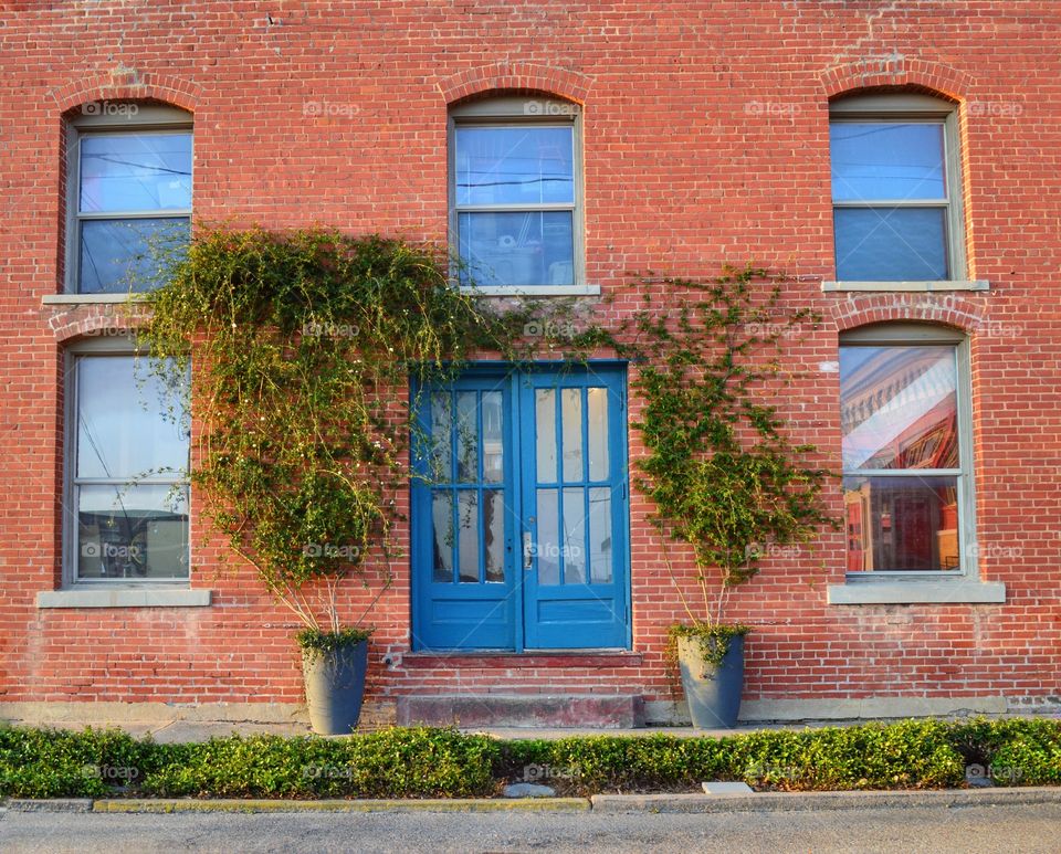 Old brick building with blue doors. 