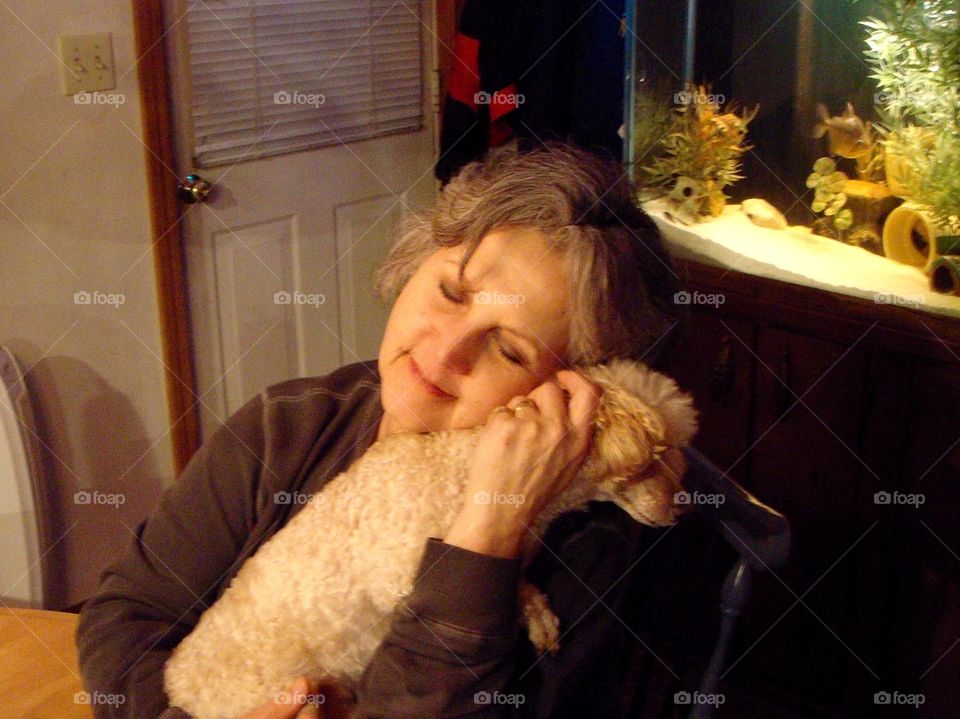 Senior woman cuddling her dog