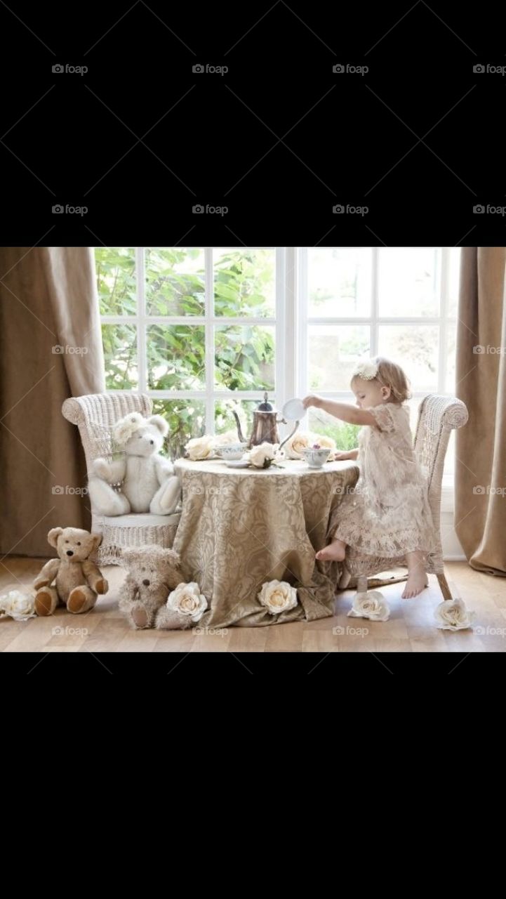 Little Girl having a Tea Party with her stuffed animals