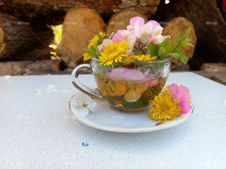 glass of tea with spring flowers.