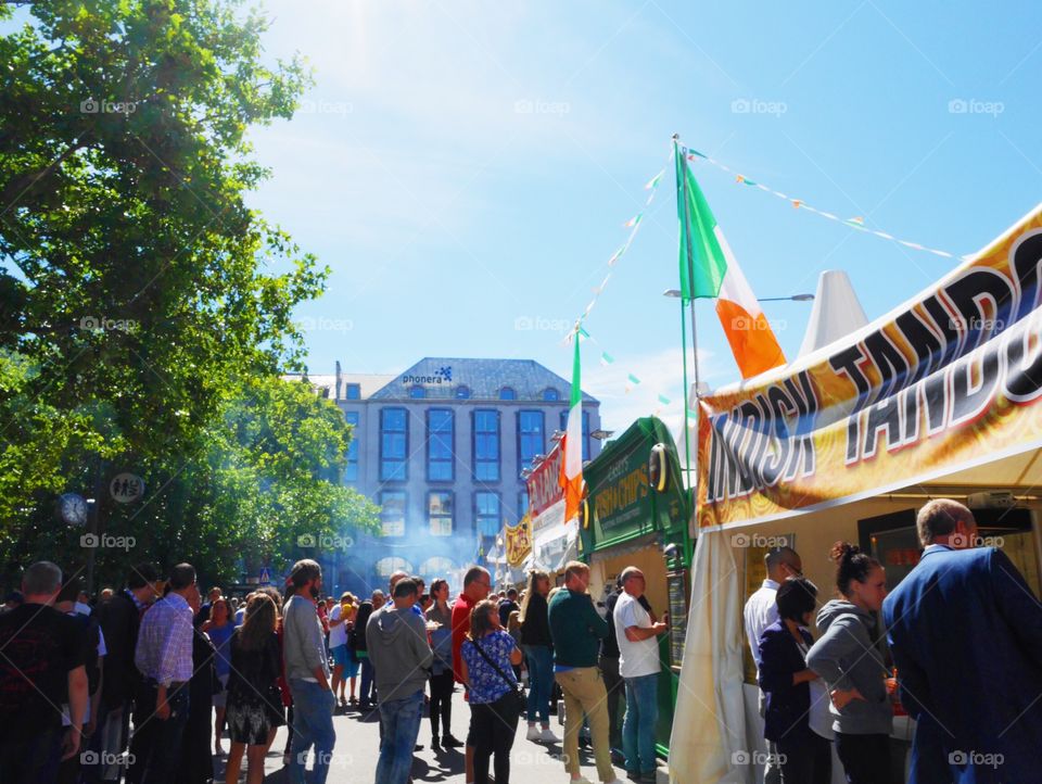 People standing in line for buying food at a festival 