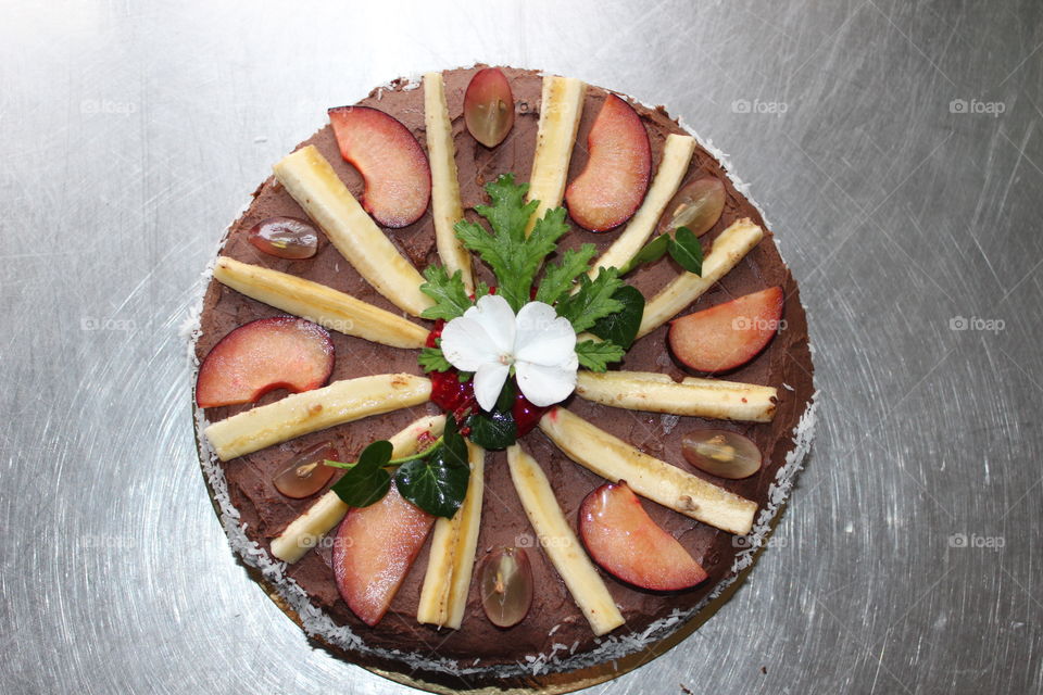 Gluten free chocolate cake with chocolate frosting. Vegan Wedding cake, decorated with fresh organic fruits