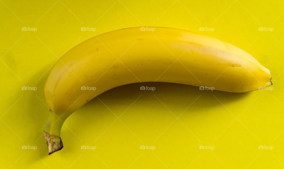 yellow banana on a yellow background