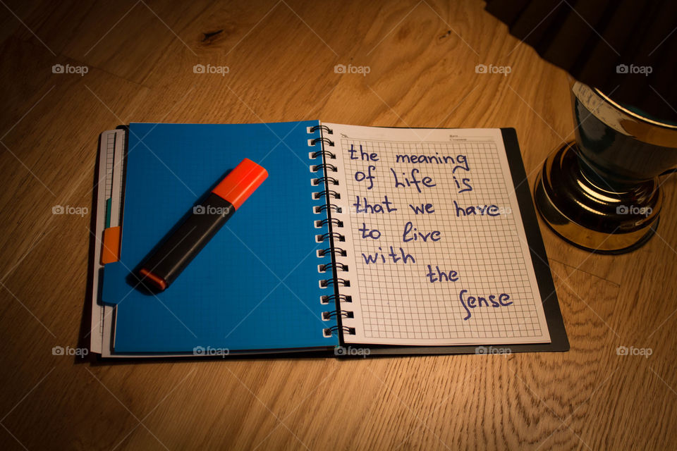 Motivational letter in a notebook on the desktop under the light of a lamp