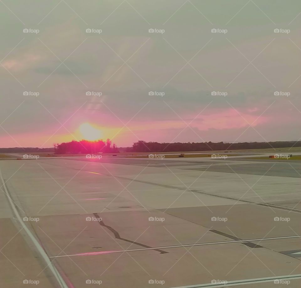 sunset over the airport runway