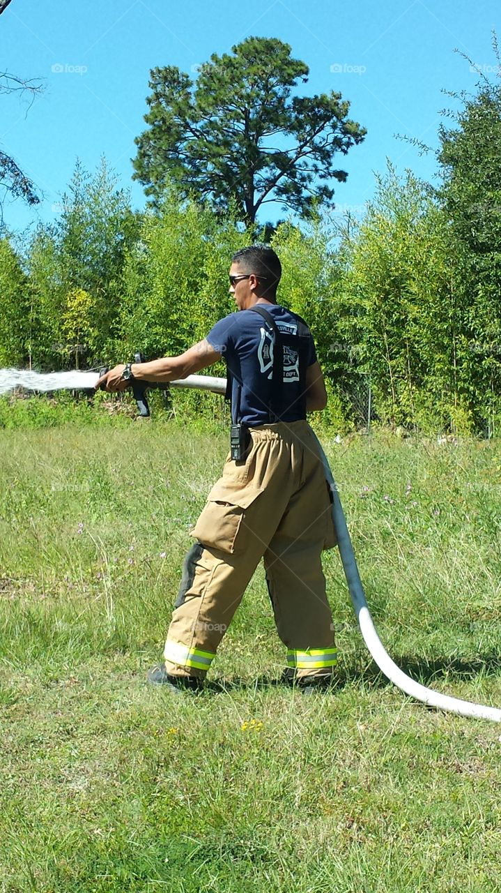 Fireman. Keeping a fire contained to a large pile