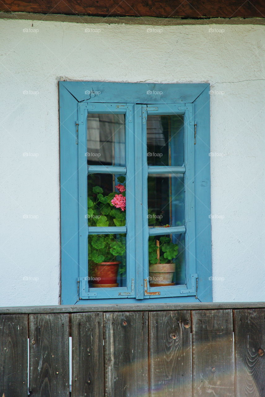Traditional blue window with white wall
