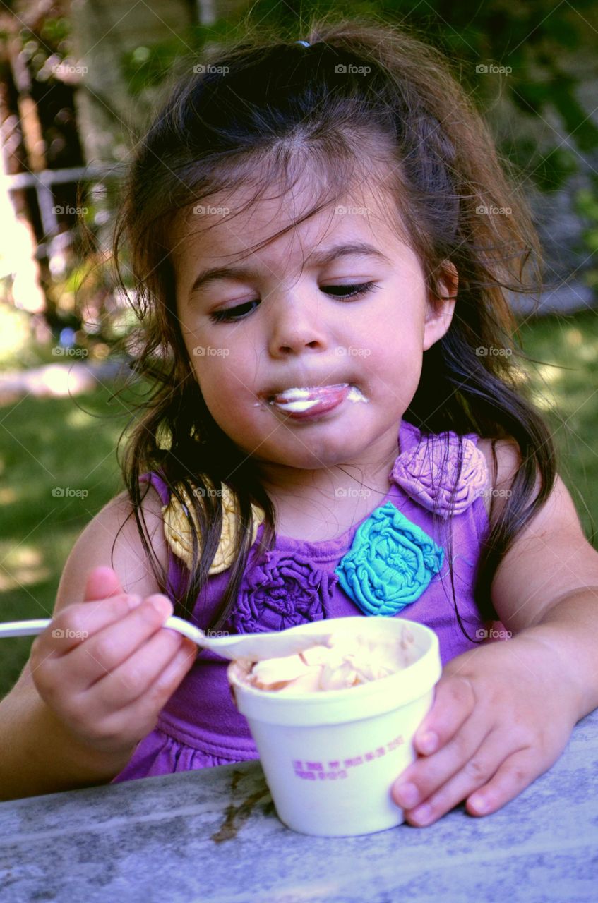 Cute girl eating ice cream