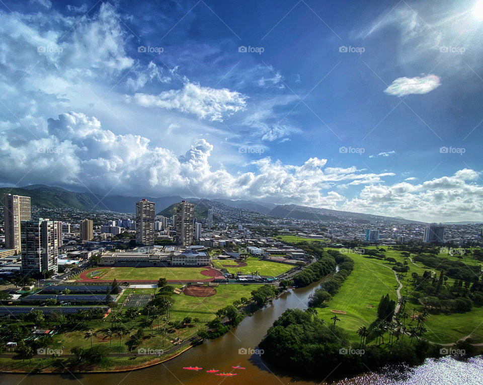 Honolulu, Hawaii landscape with clouds above the Ko’olau mountains and kayaks on the Ala Wai canal