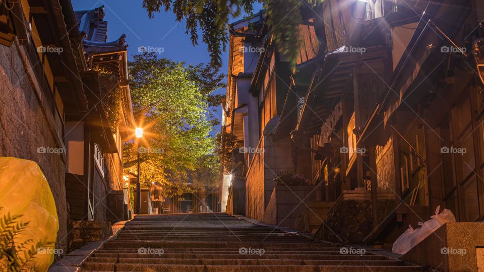 Staircase of stone tile bricks leading up the slope of Ninennzaka (Nineizaka) and Sannenzaka Historic District in Kyoto, Japan. Traditional Japanese architecture is seen throughout the ancient capital city. 