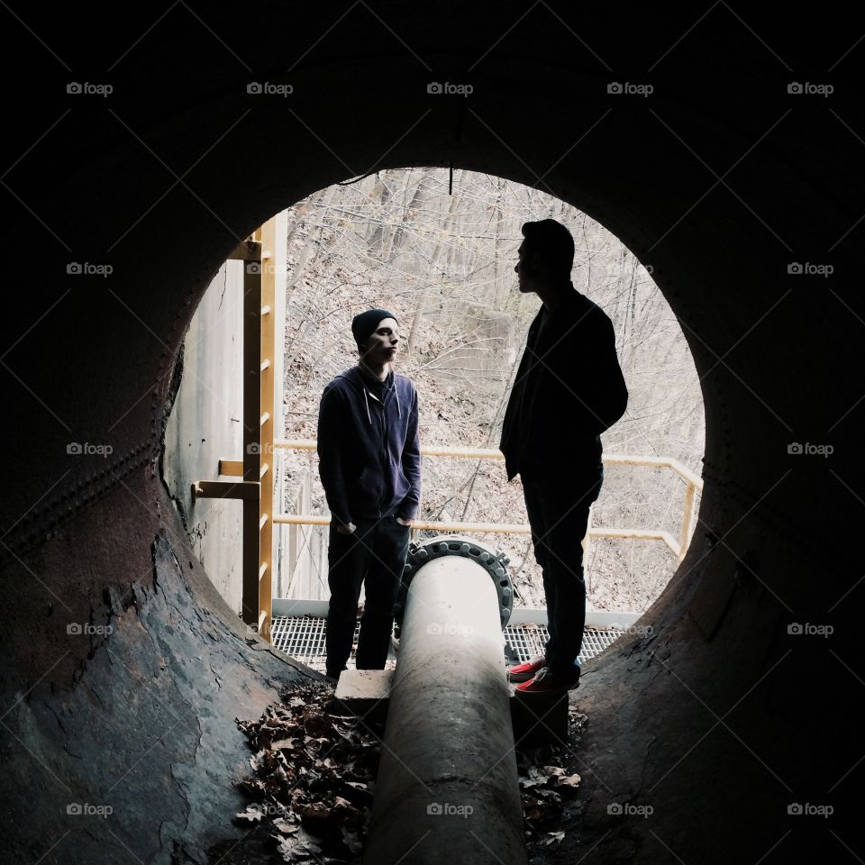 Two friends standing together in tunnel