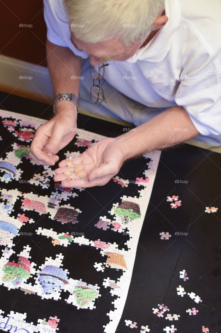 Putting a puzzle together with Grandpa 